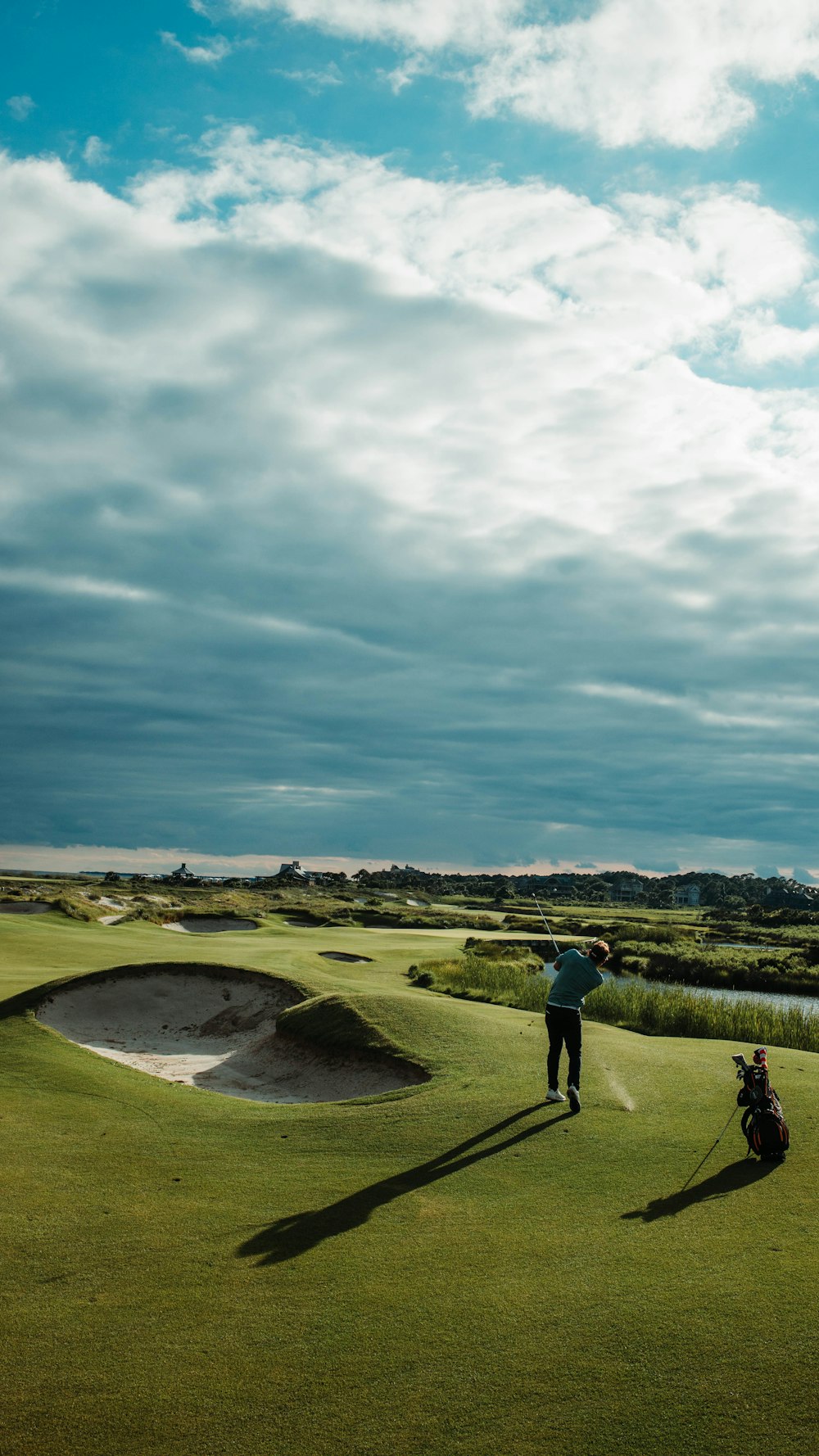 Golfer putting at sunset